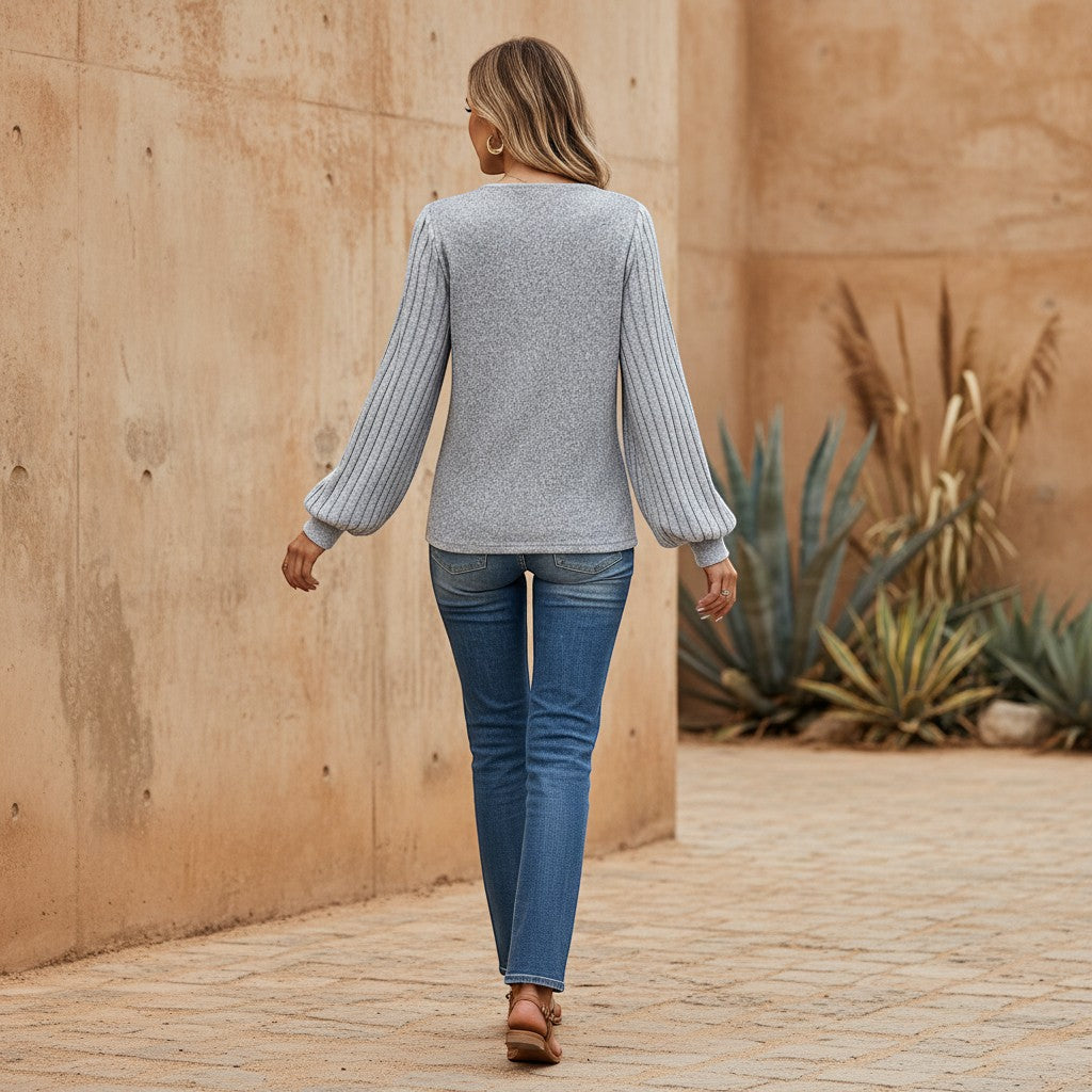 Bellem Trading grey marled knit blouse with structured balloon sleeves featuring vertical ribbing detail.