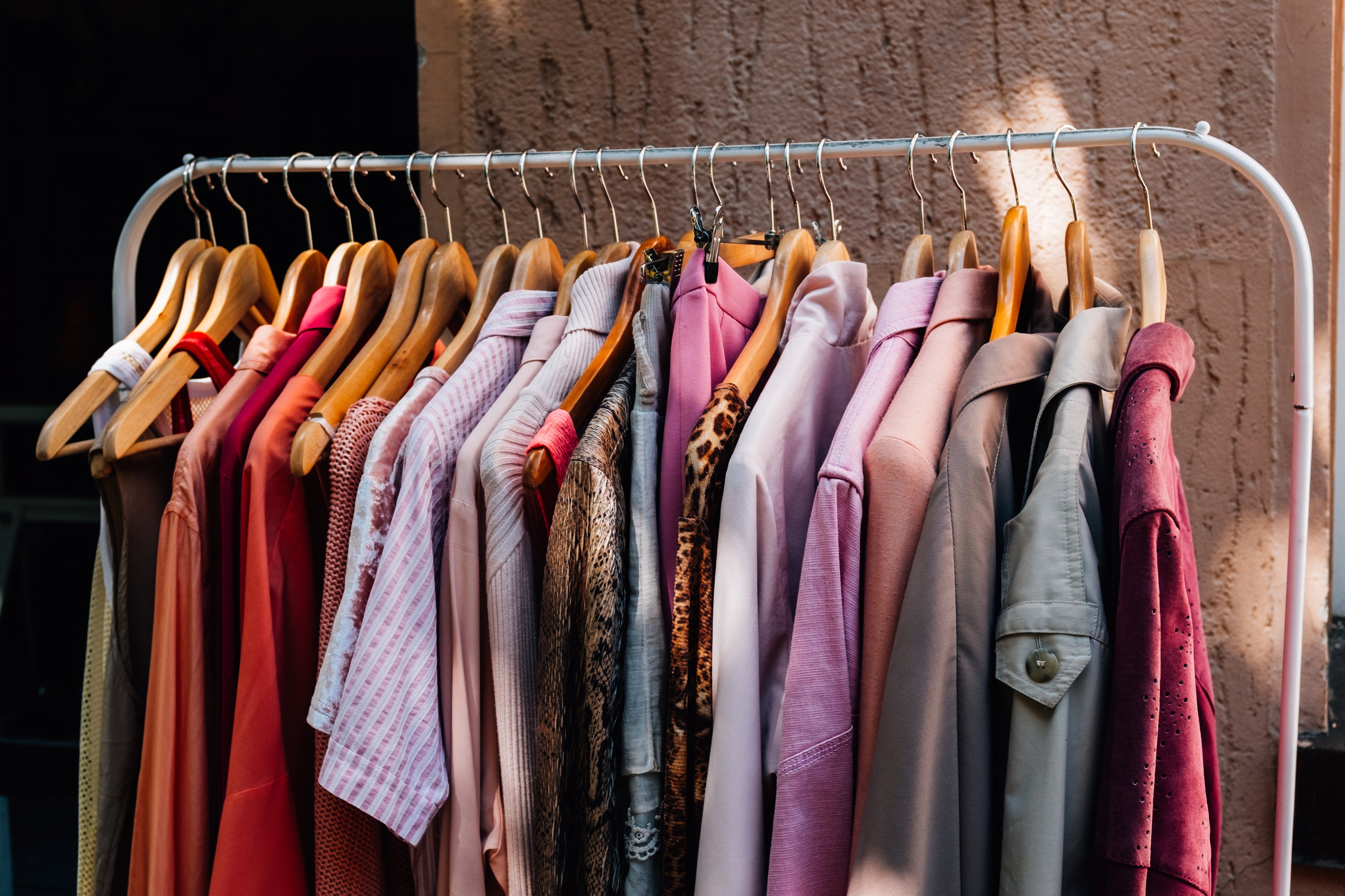 Women’s fashion clothing rack with trendy dresses, sweaters, and accessories at Bellem Trading